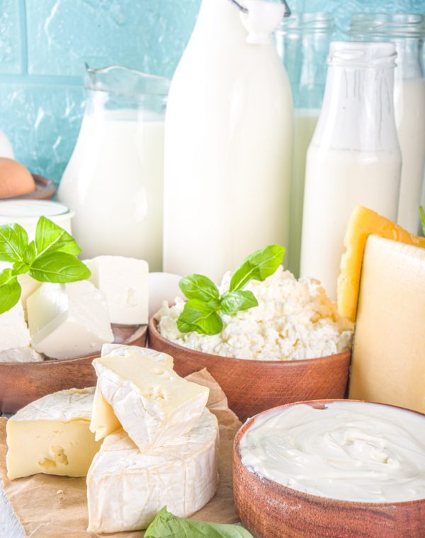 Set of Various Fresh Dairy Products - milk, cottage cheese, cheese, eggs, yogurt, sour cream, butter on wooden background