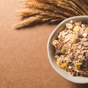 Top view of oatmeal flakes in a bowl on wooden table. Healthy breakfast concept. copy space